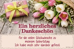 Rosa und weiße Tulpen neben einem Geschenk auf Holz, Text: Ein herzliches Dankeschön für die vielen Glückwünsche zu meinem Geburtstag. Ich habe mich sehr darüber gefreut.