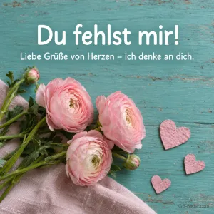 Rosa Ranunkeln auf türkisem Holz, Text: Du fehlst mir! Liebe Grüße von Herzen