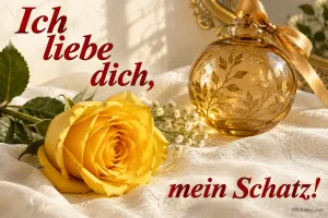 Gelbe Rose und goldene Kugel auf weißem Stoff, Text: Ich liebe dich, – mein Schatz!
