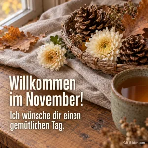 Korb mit Tannenzapfen und Chrysanthemen neben einer Teetasse, Text: Willkommen im November! Ich wünsche dir einen gemütlichen Tag.