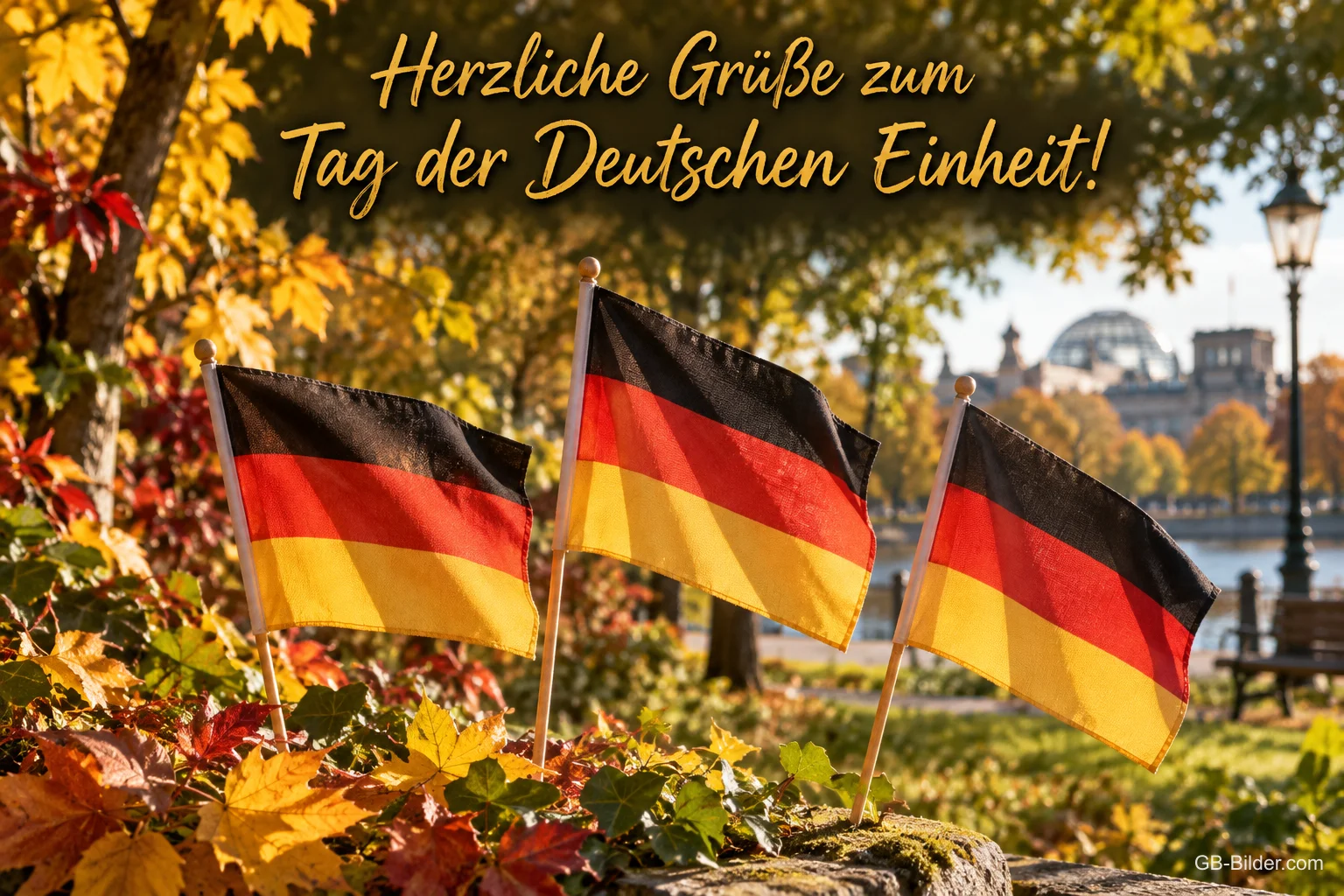 Drei Deutschlandfahnen im Herbstlaub vor dem Reichstag, Text: Herzliche Grüße zum – Tag der Deutschen Einheit!